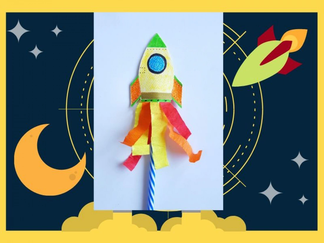 Kolorowa rakieta z papieru, ozdobiona papierowymi wstążkami, umieszczona na niebieskiej słomce.