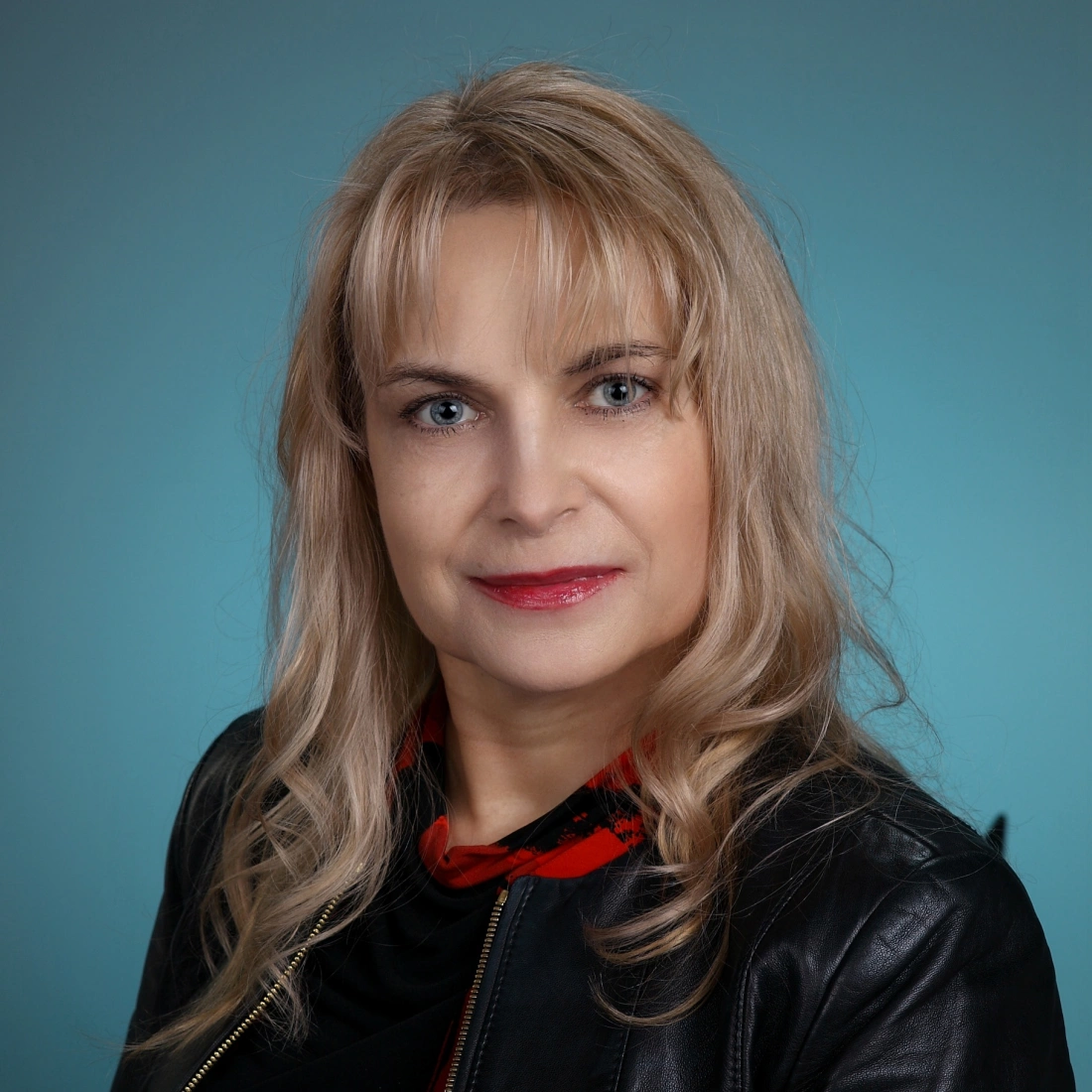 Mężczyzna w czarnej koszuli, zamyślony, z ręką przy ustach.